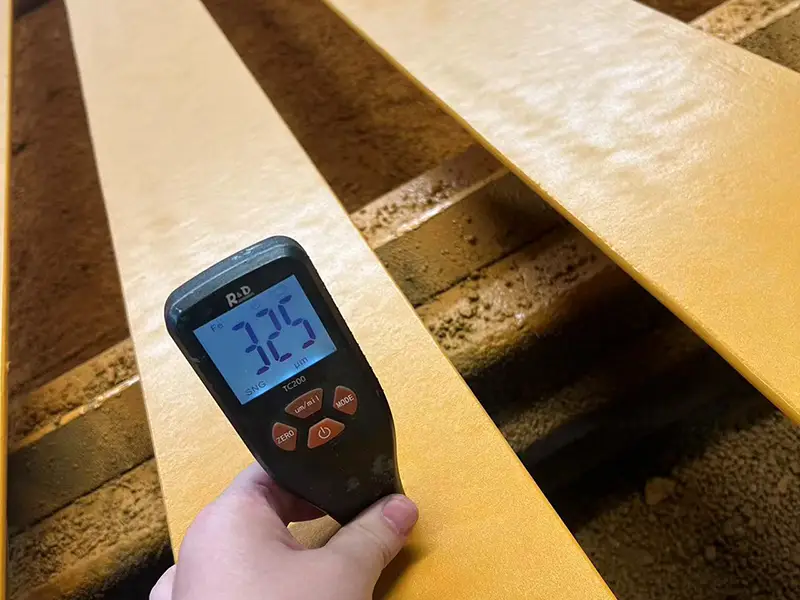 A65 crane rail paint thickness gauge showing DFT reading above 320 microns