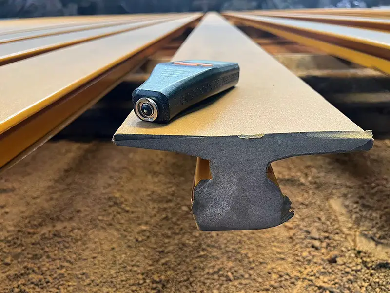 Protective film masking on A65 crane rail cross-section to keep welding area paint-free