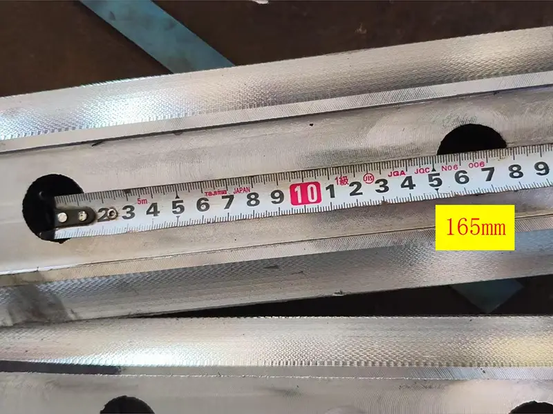 S49 rail fishplate hole spacing measurement with caliper verifying bolt positions